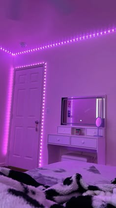 a bedroom with purple lights and a white dresser