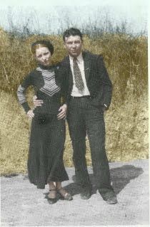 an old photo of two people standing next to each other