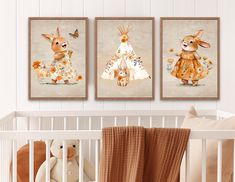 a baby's room with three pictures hanging on the wall