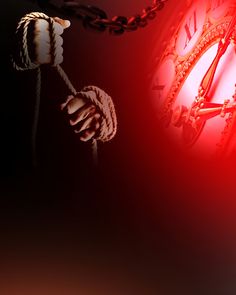 a red clock with chains hanging from it's sides and hands holding the clock