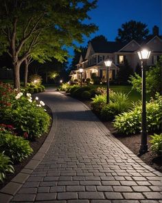 a brick walkway with lights on and trees in the background