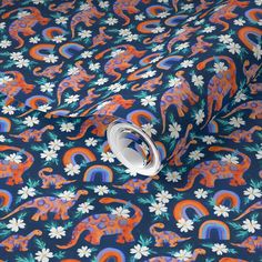 an orange and blue floral pattern on a dark background with white flowers, elephants and rainbows