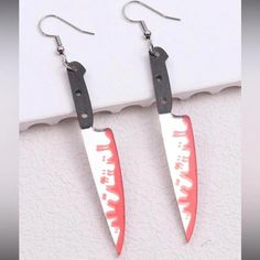 Get ready for the spooky season with these eye-catching Halloween-themed dangle drop earrings. Featuring a large, scary bloody knife design, these earrings are a must-have accessory for any festive celebration. The combination of black, red, and silver hues adds a striking contrast, making them a standout piece for your Halloween outfit. 

Crafted with attention to detail, these earrings bring a playful yet eerie vibe to your style, perfect for Halloween parties, trick-or-treat events, or just showing off your love for the holiday. Whether you're dressing up or keeping it casual, these unique earrings will elevate your festive look and make a bold statement. Embrace the spirit of Halloween with these fun and frightful accessories! Spirit Of Halloween, Red And Silver, Knife Design, Halloween Outfit, Halloween Parties, Spirit Halloween, Unique Earrings, Halloween Outfits, Spooky Season