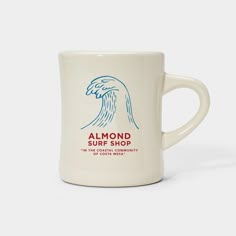 a white coffee mug with the words almond surf shop on it