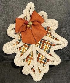 a christmas ornament made out of fabric and burlocks with a bow