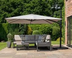 a patio with an umbrella and furniture on it