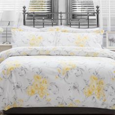 a bed with yellow and white flowers on it