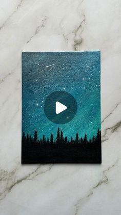 a card with an image of the night sky and trees on it, which has a play button