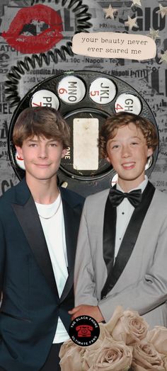 two boys in tuxedos standing next to each other