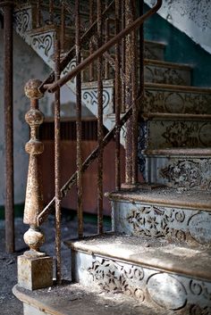 an old set of stairs with wrought iron railings