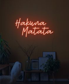 a neon sign that says hakuna matata on the side of a wall