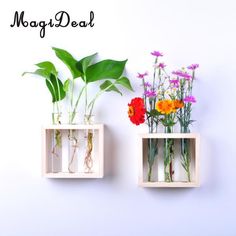 two vases with flowers and plants in them