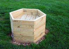 a wooden box sitting on top of a lush green field