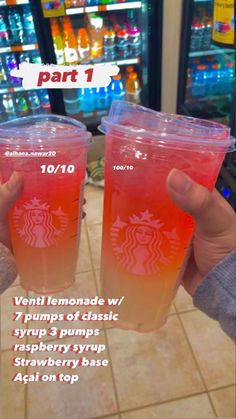 two plastic cups filled with liquid sitting on top of a counter next to vending machines