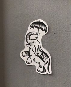 a sticker depicting an elephant with a parasol