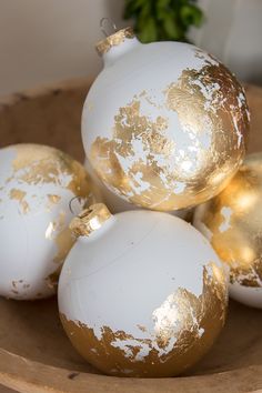 white and gold ornaments in a wooden bowl