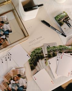 a table topped with lots of cards and photos