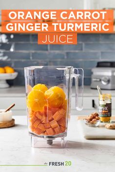 orange carrots in a blender with text overlay reading orange carrot ginger turmeric juice