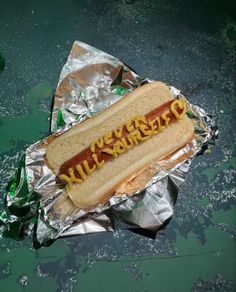 a hot dog sitting on top of aluminum foil