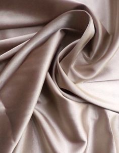 a close up view of a white satin fabric