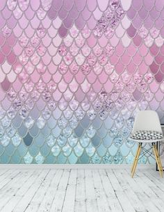 a room with mermaid scales and flowers on the wall, as well as a chair