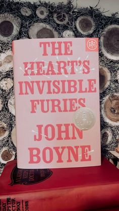 the heart's invisible furies by john boyne on top of a red book