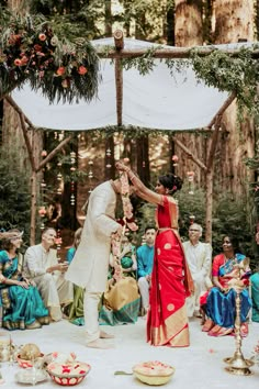 a couple getting married in front of an outdoor ceremony