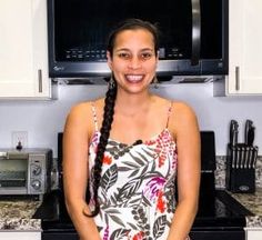 a woman standing in front of an oven