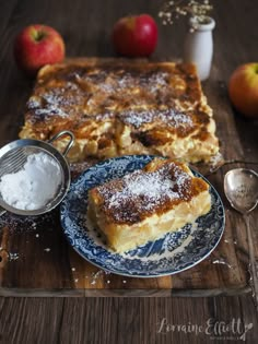 two pieces of french toast sitting on top of a blue and white plate with powdered sugar