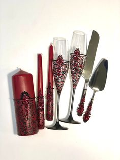 a group of wine glasses and utensils sitting next to each other on a white surface