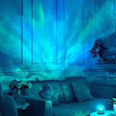 a living room filled with furniture and blue lighting