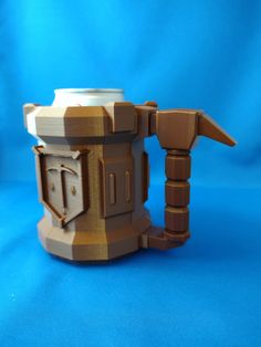 a wooden coffee cup holder made out of legos on a blue background with the lid open