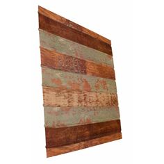 an old wooden wall hanging on the side of a white wall with wood planks