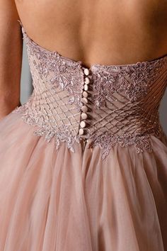 the back of a woman's dress with beading on it