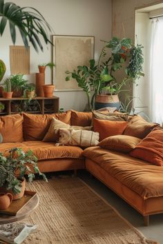 a living room filled with lots of furniture and plants