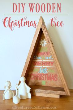 a wooden christmas tree sitting on top of a table