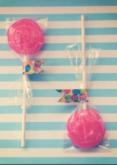 two lollipops wrapped in cellophane and sitting next to each other