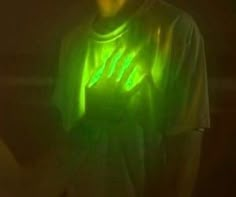 a man holding a glowing green object in his hands