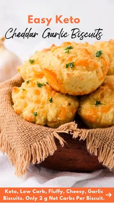 a wooden bowl filled with cheesy biscuits next to a garlic and peppercorst garnish