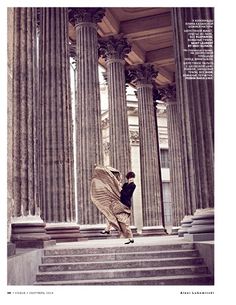 a person walking up some steps with columns