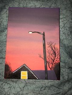 an acrylic painting of a street light and house in the background at sunset