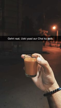 a person holding a cup in their hand with the caption, gehri raat, uskaad aur chai ka sath