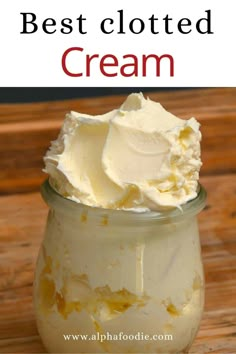 a jar filled with whipped cream sitting on top of a wooden table