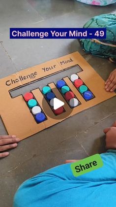 two children playing with an interactive game called challenge your mind