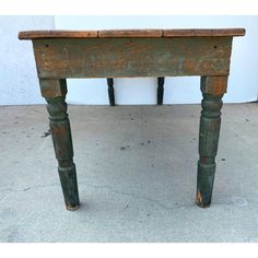 an old wooden table with two legs on the top and one leg up against it