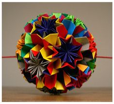 an origami ball sitting on top of a wooden table