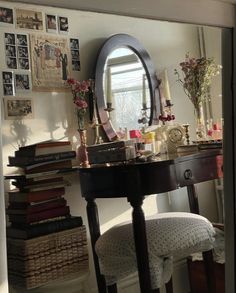 a desk with a mirror and some flowers on it