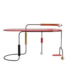 a red table with two tennis rackets and balls on the top, in front of a white background