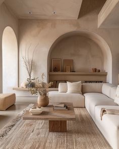 a living room filled with lots of white furniture and decor on top of a rug