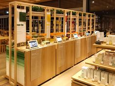 a store filled with lots of wooden shelves and tables covered in laptops on top of them